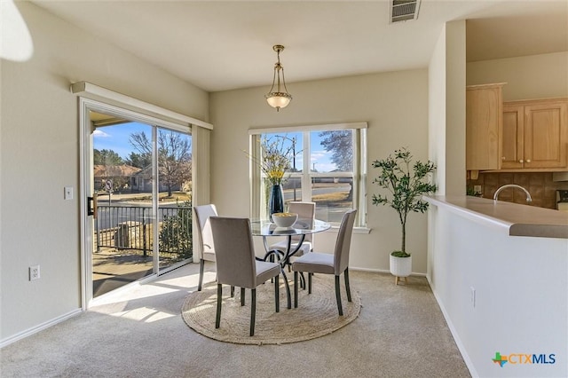 carpeted dining space featuring sink