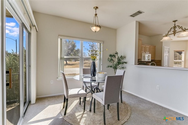 dining room featuring light carpet