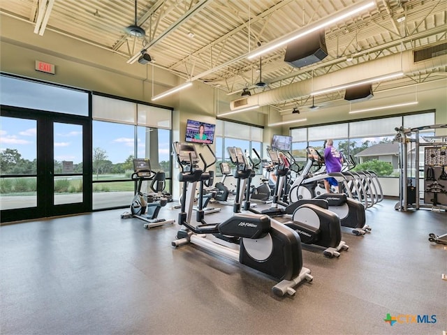 workout area with a high ceiling