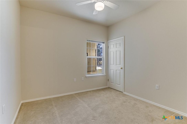 empty room with light colored carpet and ceiling fan