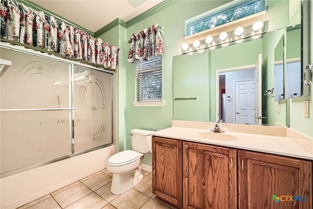 109 Ranch House Cv, Georgetown, TX 78633 - bathroom featuring vanity, toilet, tile patterned flooring, shower / bath combination with glass door, and ornamental molding
