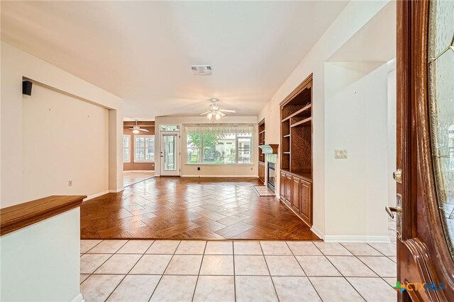 109 Ranch House Cv, Georgetown, TX 78633 - unfurnished living room featuring a ceiling fan, baseboards, and a glass covered fireplace
