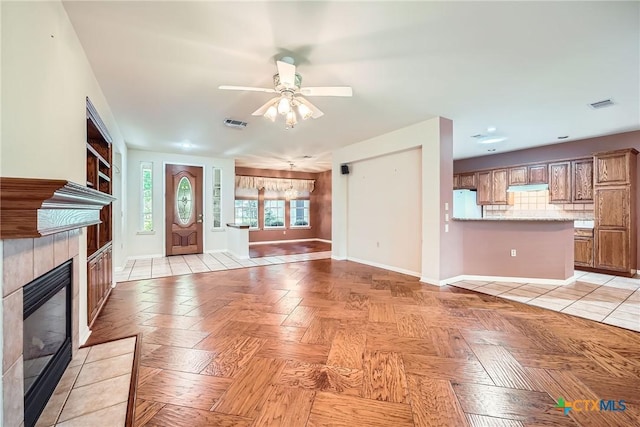 109 Ranch House Cv, Georgetown, TX 78633 - unfurnished living room featuring a fireplace, a ceiling fan, and baseboards