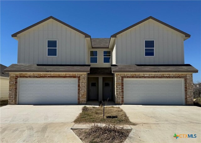 view of front of property featuring central AC and a garage