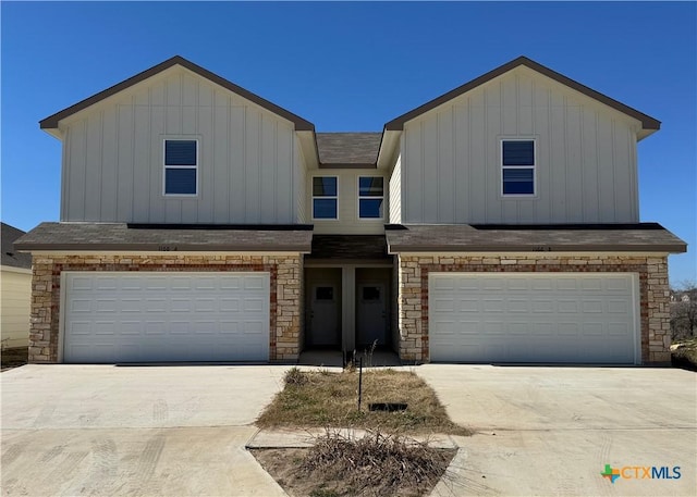 view of front of property featuring an attached garage, driveway, and board and batten siding