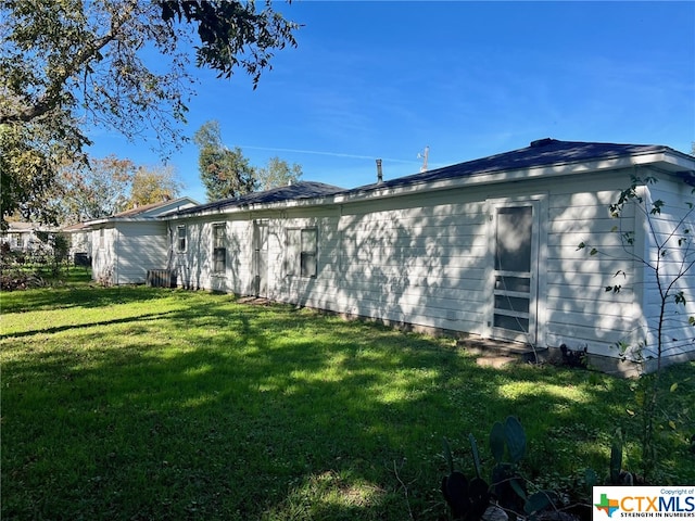 view of side of home featuring a yard