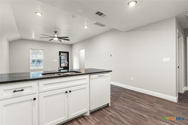 1935 Ross Ave, Waco, TX 76706 - kitchen featuring white dishwasher, a sink, dark wood-style floors, baseboards, and white cabinetry