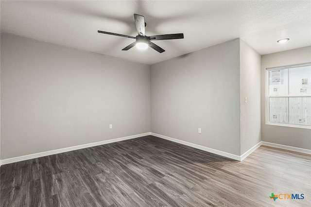 1935 Ross Ave, Waco, TX 76706 - empty room featuring dark wood-type flooring, baseboards, and ceiling fan