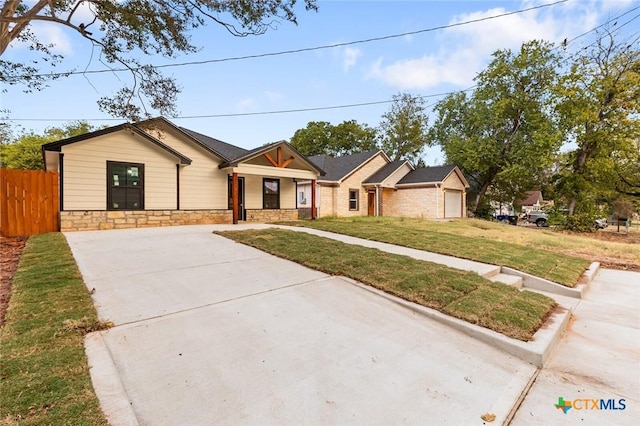 1935 Ross Ave, Waco, TX 76706 - view of front of house featuring concrete driveway, stone siding, and covered porch