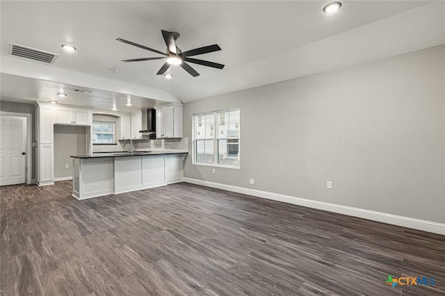 1935 Ross Ave, Waco, TX 76706 - unfurnished living room featuring ceiling fan, baseboards, dark wood-style flooring, healthy amount of natural light, and vaulted ceiling
