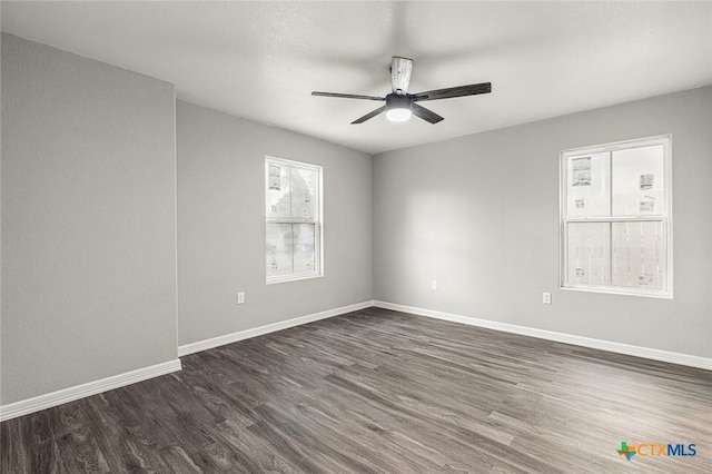 1935 Ross Ave, Waco, TX 76706 - empty room with dark wood-style floors, a ceiling fan, and baseboards