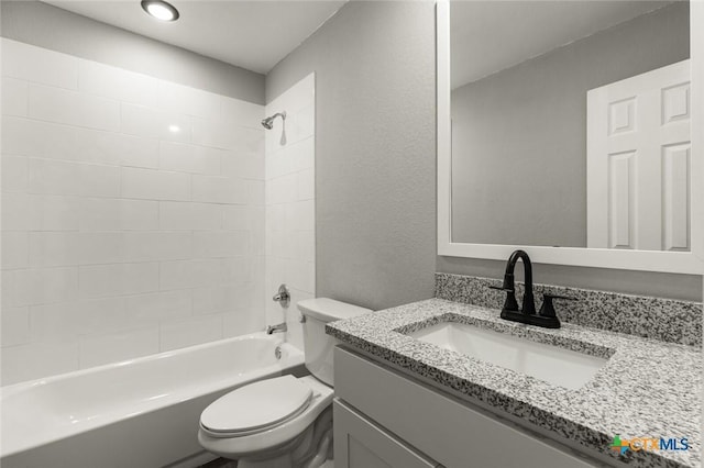 1935 Ross Ave, Waco, TX 76706 - bathroom with toilet, bathing tub / shower combination, vanity, and a textured wall