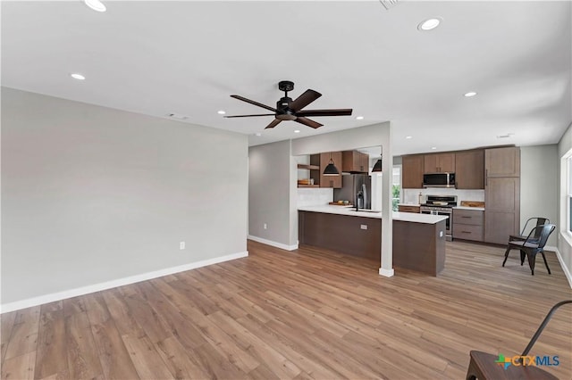 594 E S St, New Braunfels, TX 78130 - kitchen with stainless steel appliances, light countertops, open shelves, recessed lighting, and ceiling fan