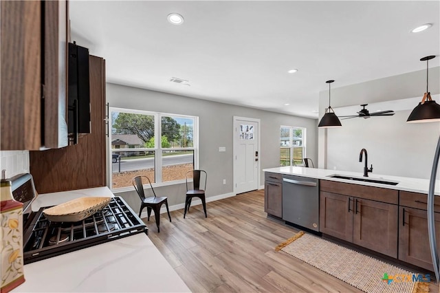 594 E S St, New Braunfels, TX 78130 - kitchen with dishwasher, light wood-style floors, light countertops, recessed lighting, and pendant lighting