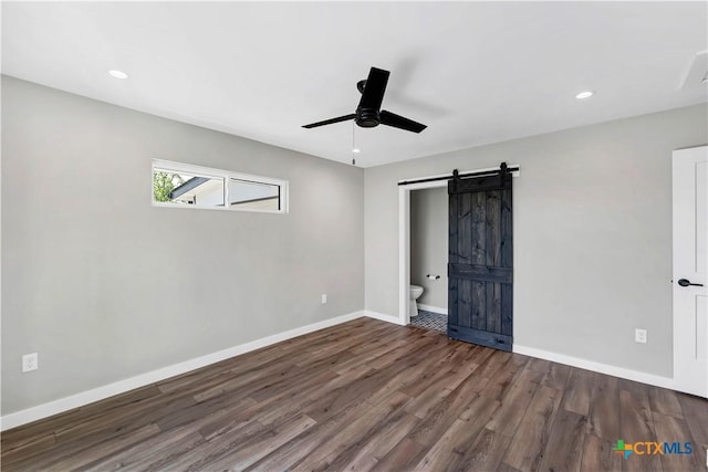 594 E S St, New Braunfels, TX 78130 - unfurnished bedroom with a barn door, wood finished floors, recessed lighting, a ceiling fan, and ensuite bathroom