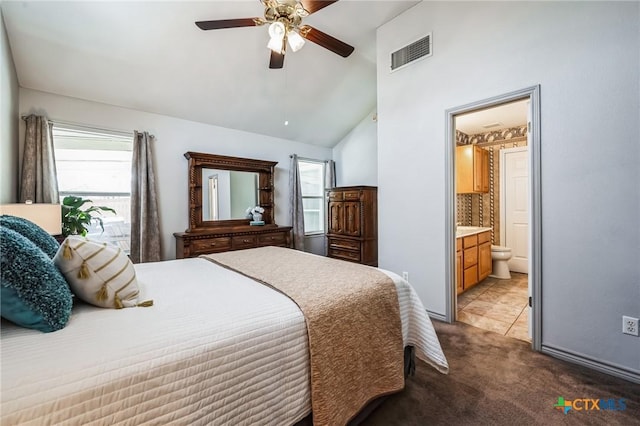 bedroom with visible vents, a ceiling fan, connected bathroom, lofted ceiling, and carpet floors