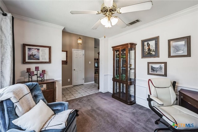 home office with carpet floors, visible vents, crown molding, and ceiling fan