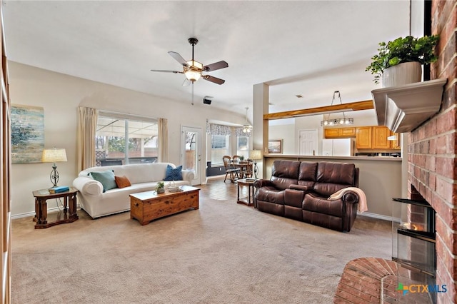 living room with carpet floors, a brick fireplace, baseboards, and a ceiling fan