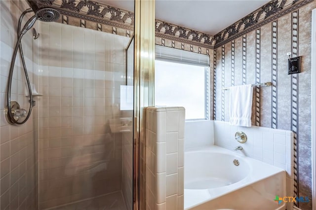 bathroom with a shower stall and a bath