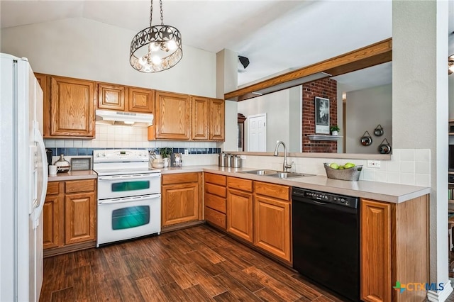 kitchen with tasteful backsplash, white appliances, a sink, and under cabinet range hood