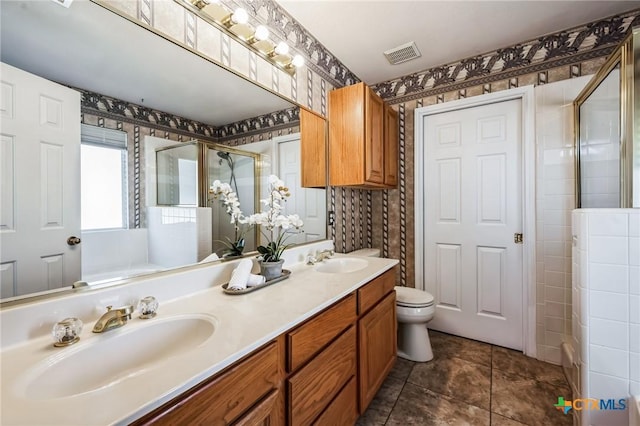 full bath with toilet, a sink, visible vents, and a shower stall