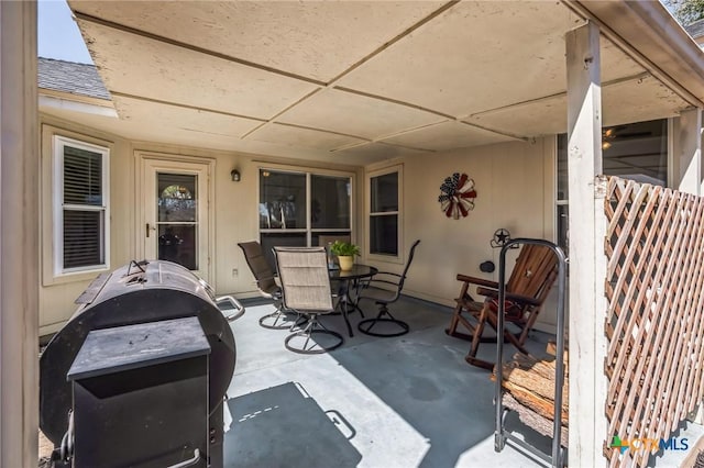 view of patio with outdoor dining area and grilling area