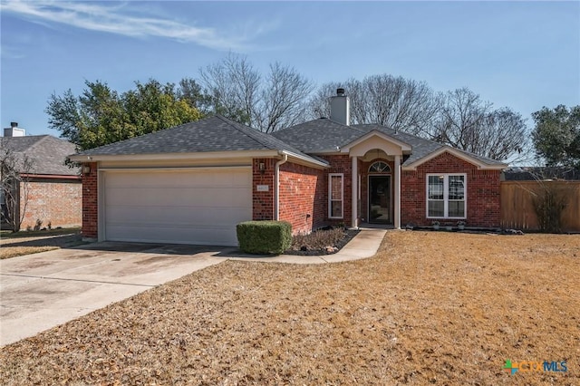 ranch-style house with driveway, a chimney, roof with shingles, an attached garage, and brick siding