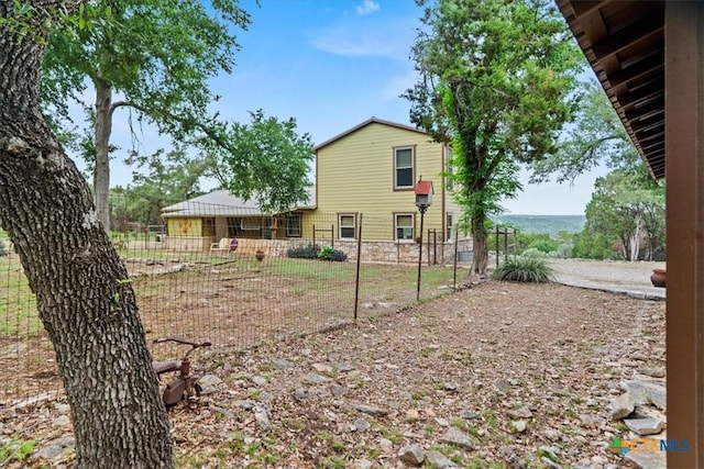 back of house featuring fence