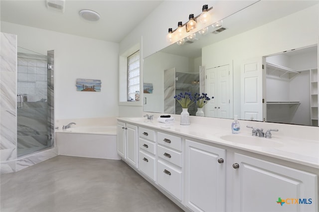 bathroom featuring vanity, concrete flooring, and shower with separate bathtub