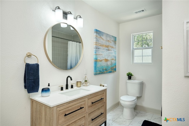 bathroom featuring toilet, vanity, and walk in shower