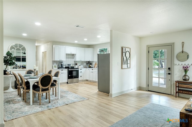 dining space featuring light wood-type flooring