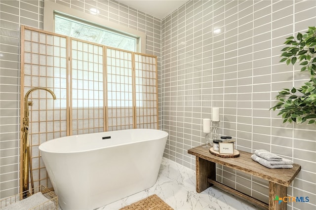 bathroom with tile walls and a tub to relax in