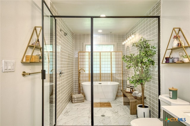 bathroom featuring tile walls, vanity, and plus walk in shower