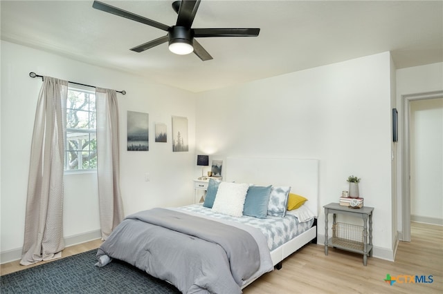 bedroom with ceiling fan and light wood-type flooring