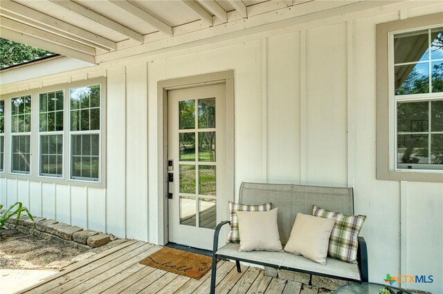 view of exterior entry with a wooden deck