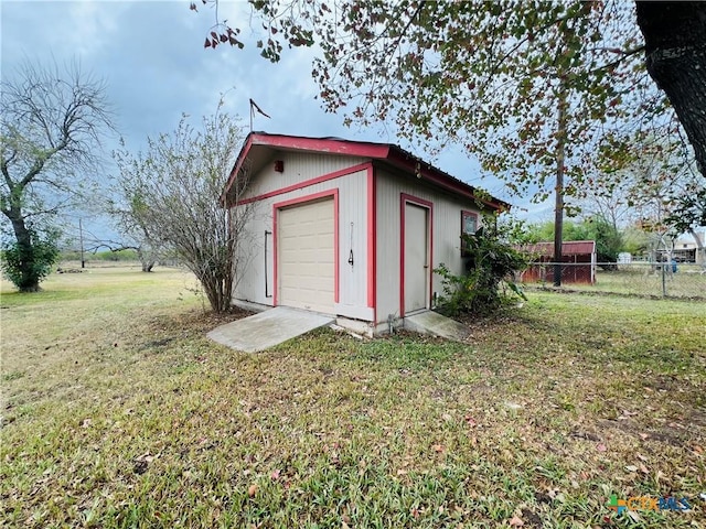 view of outbuilding with a garage and a yard