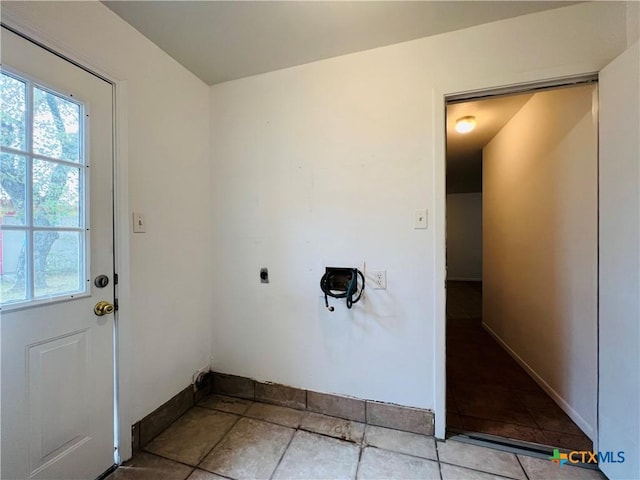 laundry area featuring electric dryer hookup and light tile patterned floors