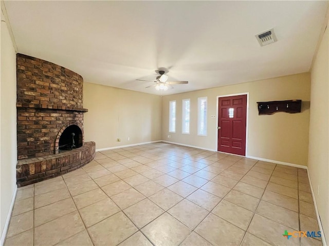 unfurnished living room featuring ceiling fan, light tile patterned flooring, and a fireplace