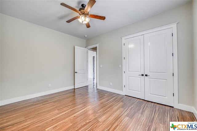 unfurnished bedroom with a closet, ceiling fan, and light hardwood / wood-style flooring