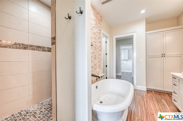 bathroom with vanity, shower with separate bathtub, and hardwood / wood-style flooring