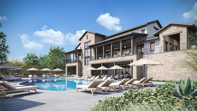 241 Sentido, Boerne, TX 78006 - rear view of property with a balcony, a patio, stone siding, and a community pool