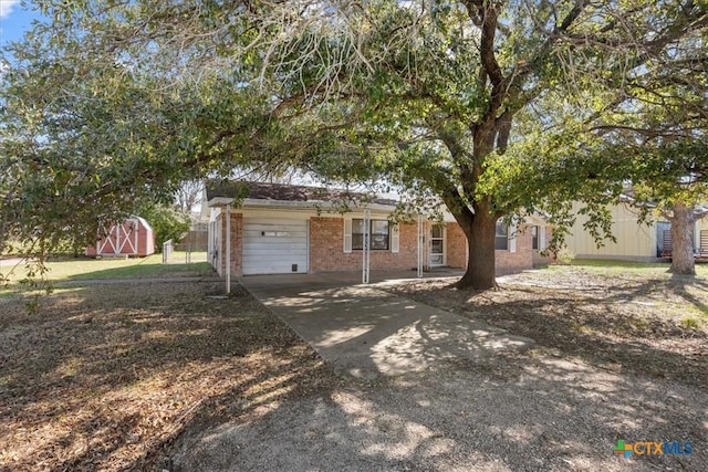 view of front facade featuring brick siding and driveway