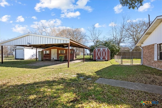 view of yard with a storage shed, an outdoor structure, and fence