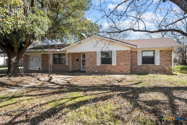 single story home featuring brick siding and an attached garage