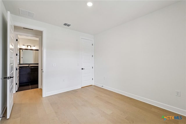 1516 Dancing Oak Ln, San Marcos, TX 78666 - unfurnished bedroom with light wood-style floors, baseboards, and recessed lighting