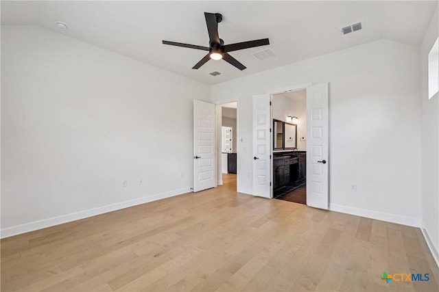 1516 Dancing Oak Ln, San Marcos, TX 78666 - unfurnished bedroom featuring vaulted ceiling, light wood-style floors, baseboards, ensuite bath, and ceiling fan