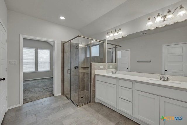 bathroom featuring vanity and an enclosed shower