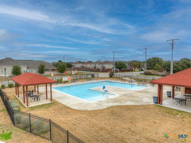 view of pool with a gazebo, a patio area, and a lawn