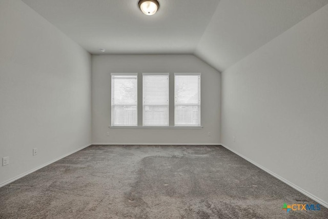 bonus room featuring lofted ceiling and carpet floors