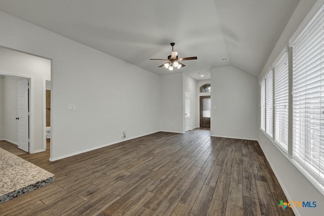 unfurnished living room featuring dark wood-type flooring, ceiling fan, and vaulted ceiling